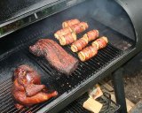 Chicken, pork and corn cooked in a barbecue smoker